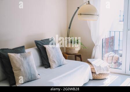 living room of a small apartment with vintage lamp and exit to balcony Stock Photo