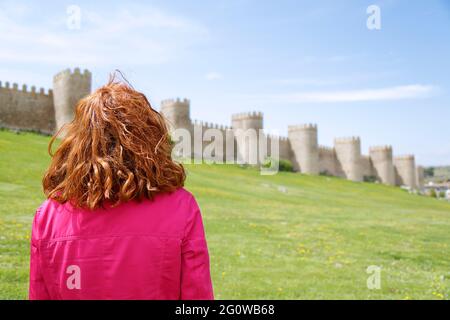 Woman enjoying the view of the Walls of Avila located in Spain Stock Photo