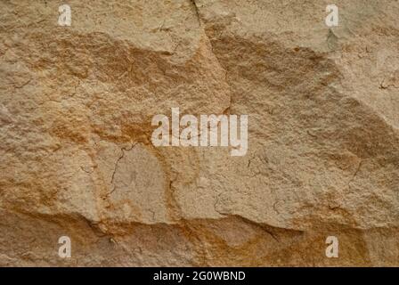 Sandstone wall background, relief texture, close-up view Stock Photo