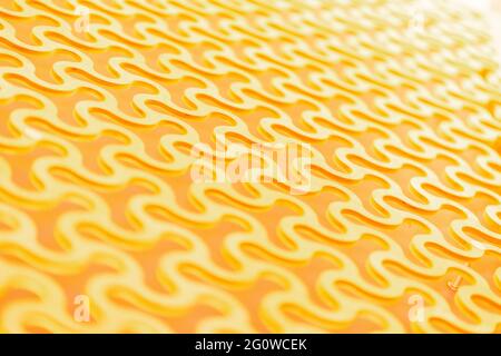 Abstract background, a repeating pattern of gold curved round cells in Stock Photo