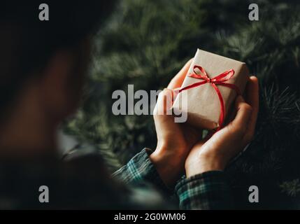 Femele hands holding gif boxt. Ideas for christmas decoration and gifts. Christmas and New year concept. Stock Photo