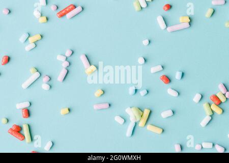 Blue background with colourful candy sprinkle. Concept of summer and sweets. Illustration 3d. copy space. close up Stock Photo