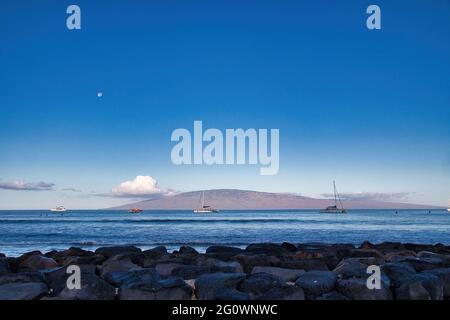 View of Lanai from Lanai harbor at dawn with moon set. Stock Photo