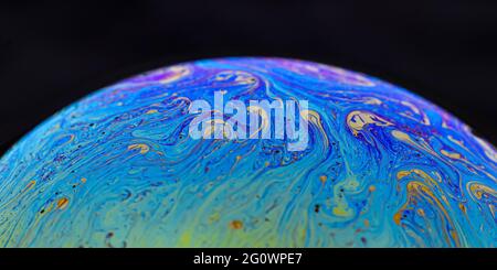 Beautiful psychedelic abstractions on the surface soap bubbles. Stock Photo