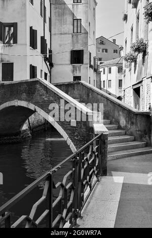Venice in Italy. Canal with small bridge. Black and white photography, venetian view Stock Photo