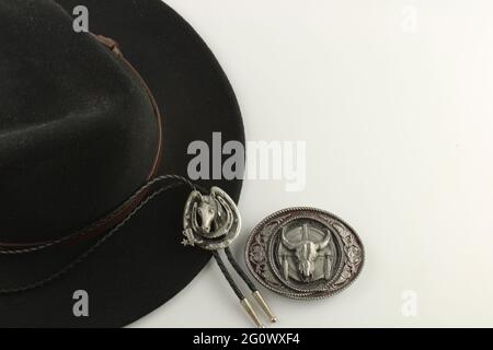 Cowboy hat, bolo tie and belt buckle with copy space. Wild west Concept with copy space Stock Photo