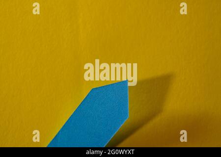 Closeup shot of a blue self-adhesive note on a yellow background Stock Photo