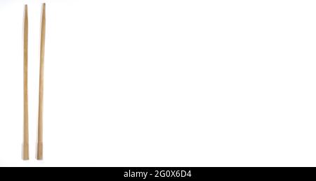 Wooden chopsticks, top view of two wooden chopsticks on isolated white background with copy space, space for text Stock Photo