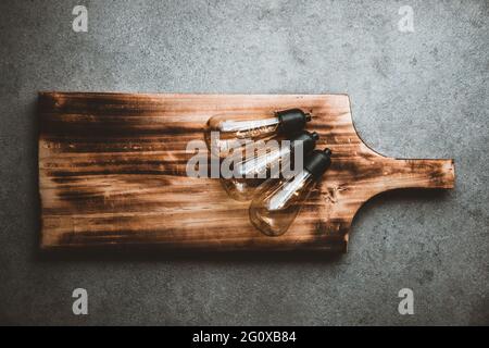 Three lamps and a wooden cutting board on kitchen counter Stock Photo
