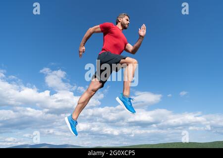 man runner on sky background. challenge and competition. marathon speed. Stock Photo