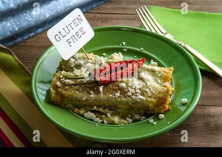 Mexican enchiladas with creamy poblano pepper sauce and queso fresco cheese Stock Photo