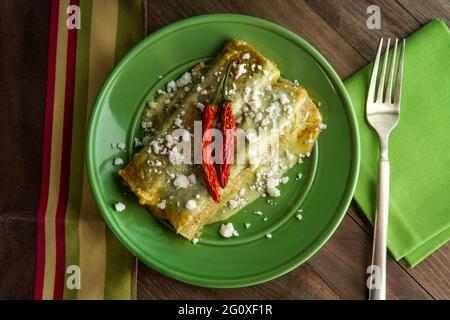 Mexican enchiladas with creamy poblano pepper sauce and queso fresco cheese Stock Photo