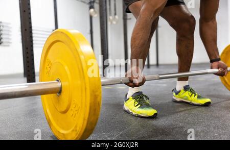 Detail of man practicing weightlifting in gym. Unrecognizable person. Close up. Stock Photo