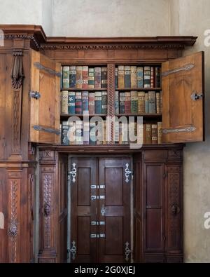 Medieval bookshelf with old books in the Old Royal Palace - Prague castle complex, Hradcany Stock Photo