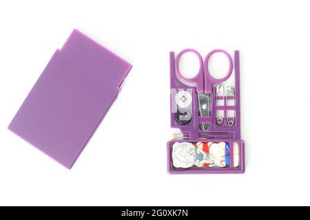 Small Sewing Kit with Needles, Multicolored Threads, scissors, Pin and Buttons isolated on white background. Stock Photo