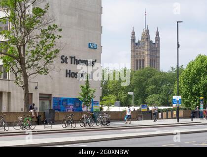St Thomas' Hospital with the Houses of Parliament behind on a sunny day. London Stock Photo