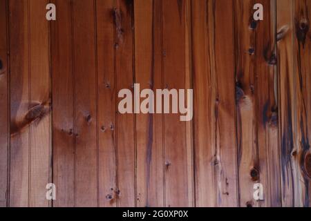 Dark stained weatherd pine wood panel wall ceiling in natural light Stock Photo