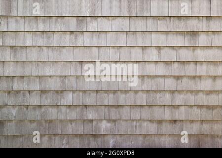 Dry aged weathered cedar shingle siding texture on an old summer cottage home building Stock Photo