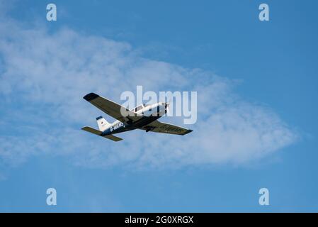 Piper PA 28 Cherokee Arrow III light aircraft plane G-WAMS climbing after taking off from London Southend Airport, Essex, UK, on a training flight Stock Photo