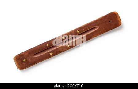 Joss stick stand isolated on white background. Indian incense stick holder of sandalwood close-up. Natural wood incense burner with seven golden stars Stock Photo