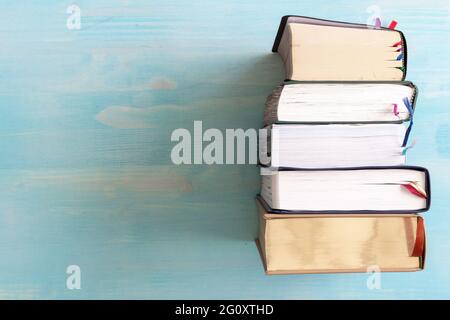 border of stack of books on blue wood background with copy space Stock Photo