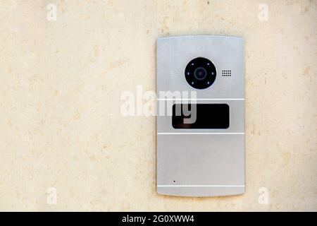 intercom with camera and card reader for safe access, access control system from thieves and criminal electronic device on a yellow wall with copy spa Stock Photo