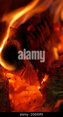 Burning firewood in the fireplace close up Stock Photo