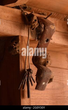 antique tools hanging in an old barn Stock Photo