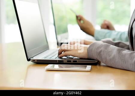 Smiling business team working on computer in office Stock Photo