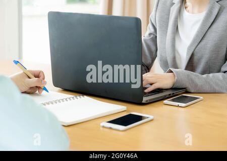 Business team hands at work with financial reports and a laptop Stock Photo