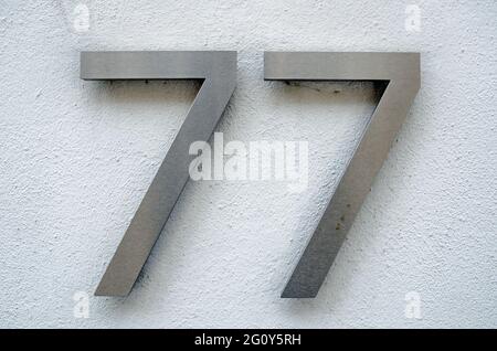 Metal numeral 77, seventy-sevendigit; isolated on white background Stock  Photo - Alamy