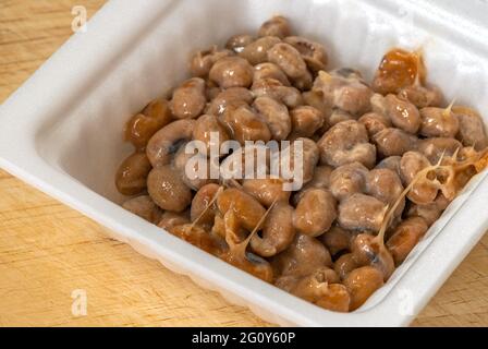 Close up Natto or Fermented Soy in foam package, melting from frozen. Stock Photo