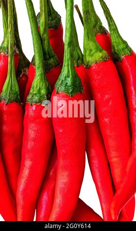Close up stack of fresh red chilli, isolated on white background. Vertical image of red chilli. Stock Photo