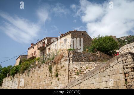 Old living houses are under cloudy sky on a summer day, Olmeto commune in the Corse-du-Sud department of France on the island of Corsica Stock Photo