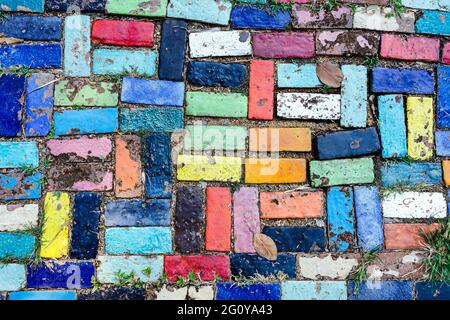 Top view on pieces of multicolored ceramic tiles decorated in garden. Old pavement of tiles textured. Street mosaic cobblestone sidewalk. Abstract,bac Stock Photo
