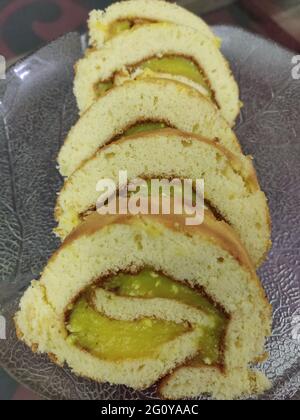 A Swiss roll, jelly roll, roll cake, cream roll, roulade or Swiss log is a type of rolled sponge cake filled with whipped cream, jam, or icing Stock Photo