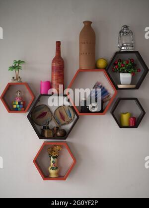 Vertical shot of ornaments and vases in decorative shelves Stock Photo