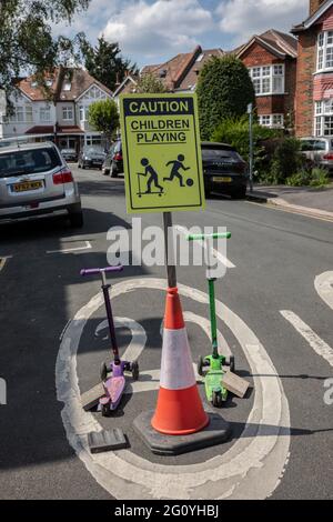 CAUTION Children playing sign positioned to slow traffic down at the entrance to residential cul-de-sac, England, United Kingdom Stock Photo