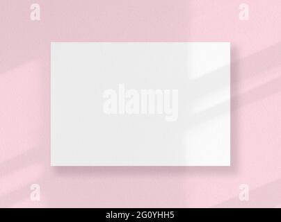 Blank square card, white sheet as mockup with sunny shadows on pink surface Stock Photo