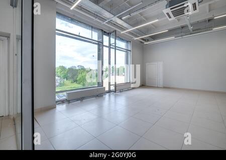 Modern white empty room interior with columns and panoramic windows.  room for office or store Stock Photo