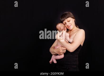 Loving mom carying of her newborn baby. Happy mother with her baby boy Stock Photo