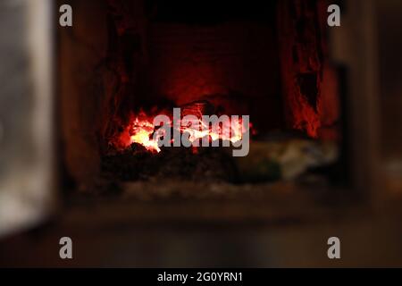 heated stove in the house with red coals and fire Stock Photo