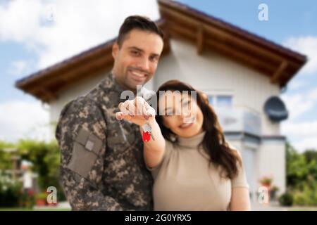 Happy Couple Holding Home Keys. Real Estate Mortgage Stock Photo