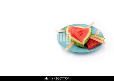 Watermelon slices popsicles on blue plate isolated on white background Stock Photo