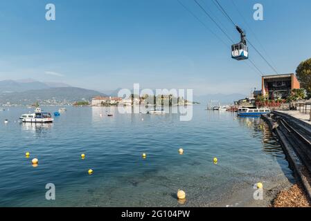 Lake Maggiore and Stresa town, Italy. Panorama with Isola Bella (beautiful island) and the cable car that leads to the mountain called Mottarone Stock Photo