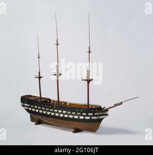 Model or a 74 to 80-gun ship of the line. Polychromed trunk branch model, painted black and white and with copper paint under the water line, with loose round wood. Two and eighty guns divided into three decks; Five levels: cow bridge, bottles, intermediate deck, baking deck and semi-deck with covered pit with walking corridors and grilles, top campanje with roef. The galleon has no shipment. Wrecked mirror, flat wull with two gates, two-storey fence with carving of weapent trophies and oval weapon with anchor; Side galleries of two floors with carvings of pilasters and diamond motifs. Stir wi Stock Photo