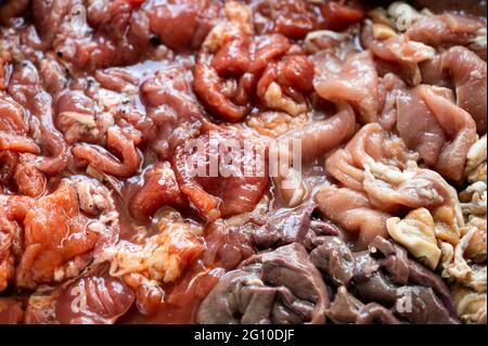 Close-up various parts of raw sliced pork with marinated pork, pork belly, pork liver in stall texture background Stock Photo
