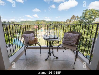 Set of afternoon tea with dessert and pillow on weave chairs on balcony in vacation Stock Photo