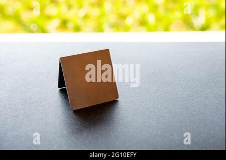 Mock up stainless menu frame, empty table tent stand on the table in restaurant Stock Photo