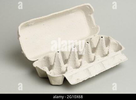 blank paper rectangular tray for chicken eggs on a gray background, close up Stock Photo